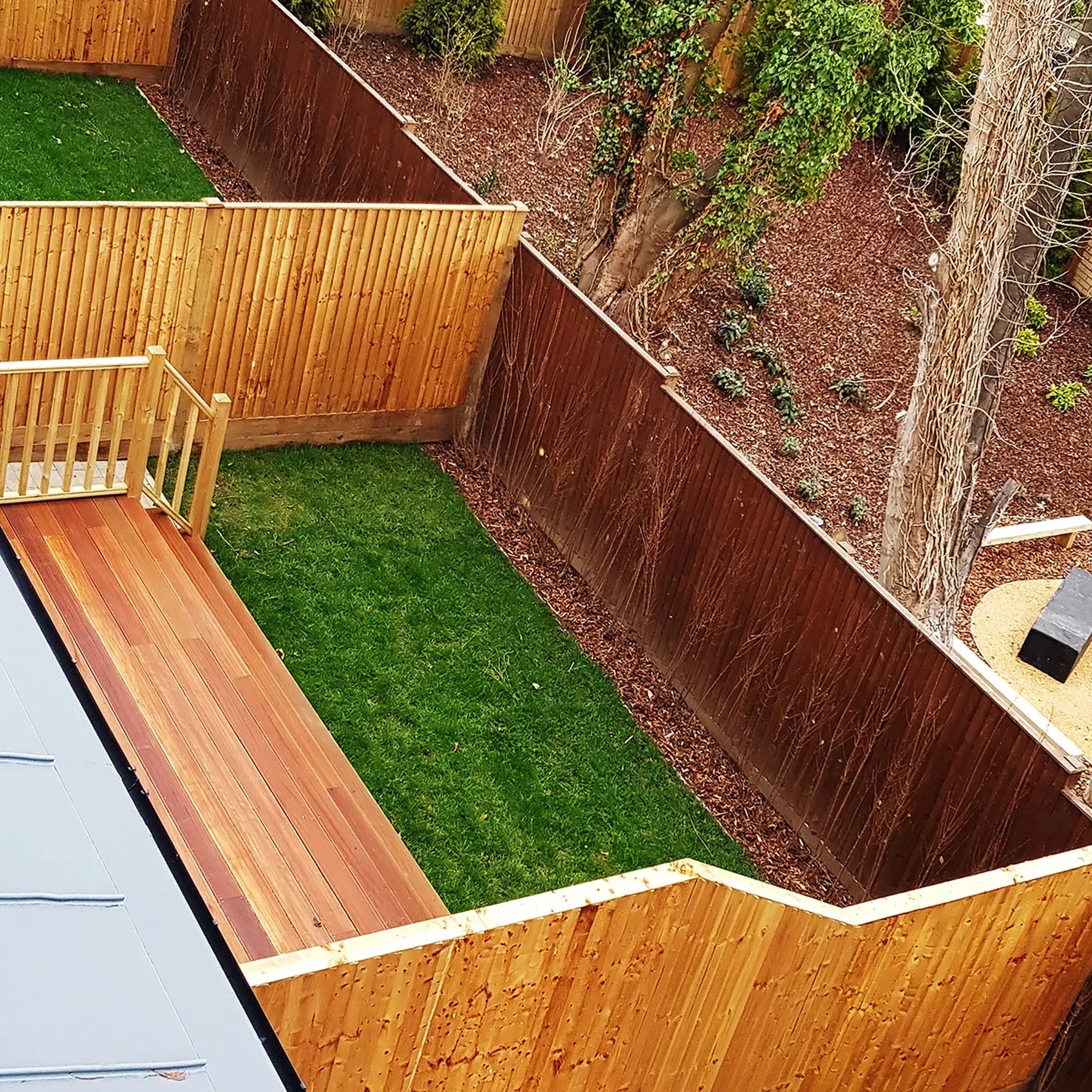 Durable composite decking with timber balustrade in South London garden